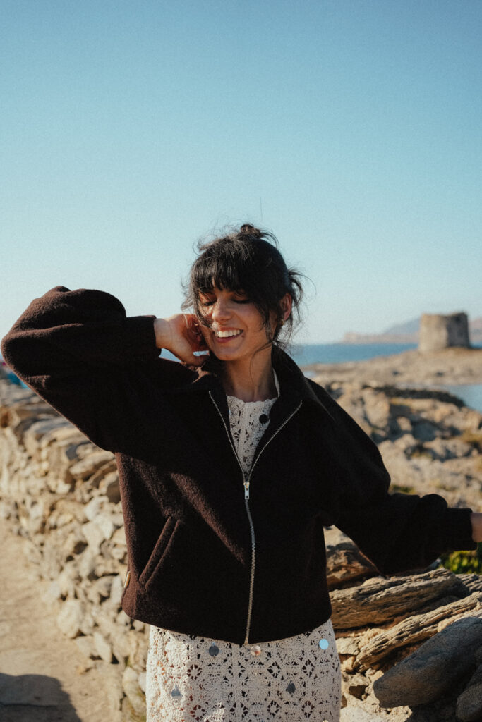 a woman wearing a brown jacket
