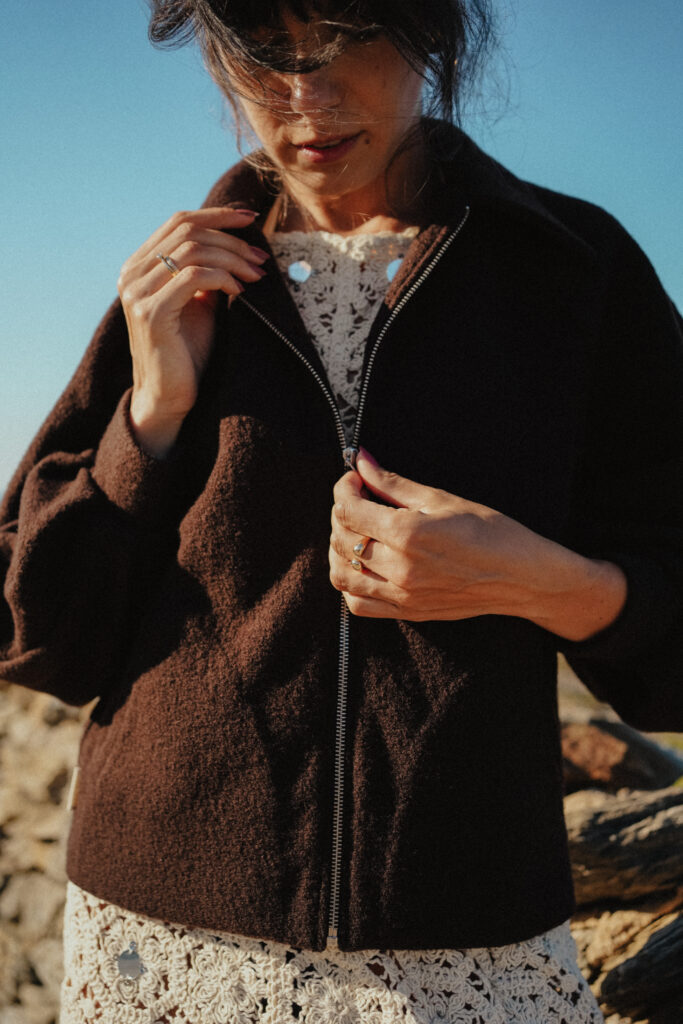 a woman wearing a brown jacket